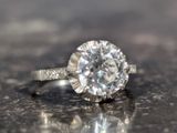 a diamond ring sitting on top of a table