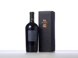 a bottle of wine sitting next to a box on top of a table