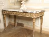a marble table with a vase on top of it