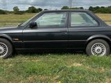 une voiture noire garée dans l'herbe