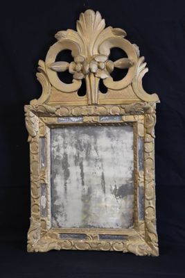an image of a mirror with a gold frame on a black background