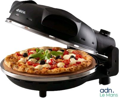 a pizza that is being cooked on a pizza stone