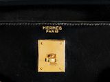 a close up of a black purse with a gold buckle
