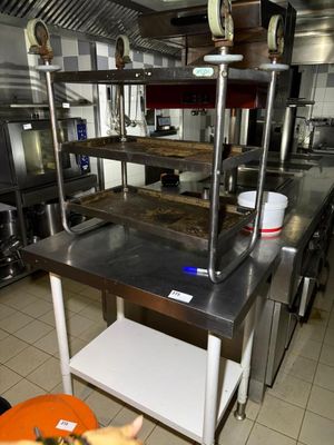 a kitchen with a lot of stainless steel counter tops