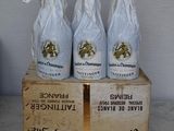 three bottles of wine sitting on top of a wooden box