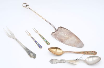 many spoons and forks that are sitting on a table