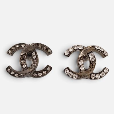 a pair of chanel earrings with crystals on them