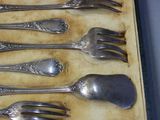 six forks and spoons in a box on a table