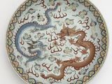 an image of a plate with a dragon and a bird on it