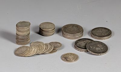 a pile of coins sitting on a table next to a pile of coins