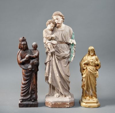 three statues of jesus, mary, and a woman holding a child