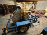 an image of a trailer with a large reel on the back of it