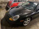 a black sports car parked next to a red vw beetle