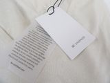 a label on a white shirt with a tag attached to it