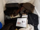 a pile of clothes and a laptop on the floor