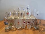 a lot of glass mugs sitting on a wooden table