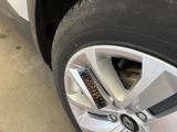 a close up of a car tire with a clock on it