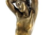 bronze statue of a woman holding a bird on her head