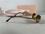 sunglasses with gold frames and a pink case sitting on a table