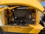 a large yellow machine that is parked in the parking lot