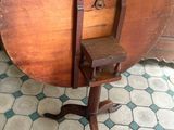 a small table with a wooden top on a stand