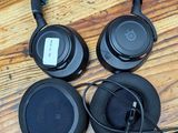 three headphones are sitting on a wooden floor next to each other