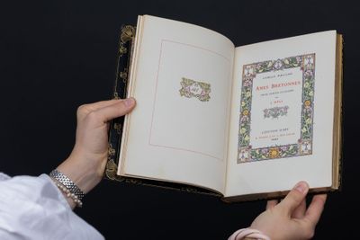 a person holding an open book with a picture on it