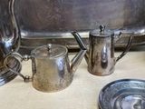a silver tea pot and a silver tea pot on a table