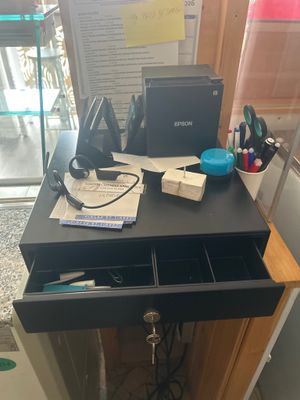 a desk with a laptop and other office supplies on it