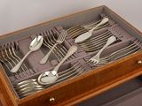 a wooden box with silverware in it on a table
