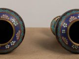 two vases that are sitting on a table