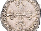 une vieille pièce d'argent ornée d'une croix