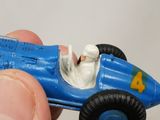 someone is holding a toy race car in their hand