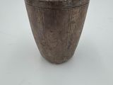 an image of a metal cup sitting on top of a white table
