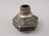a small metal object that is on a white surface