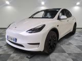 the white tesla model x is parked in the garage