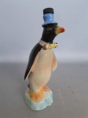 a figurine of a penguin wearing a top hat and bow tie