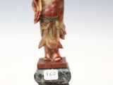 an image of a statue of a man with a red robe on a pedestal