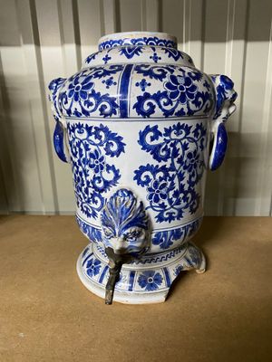 an old blue and white vase sitting on top of a wooden table
