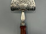 an antique silver and wood hand held mirror with a wooden handle