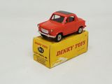 a red toy car sitting on top of a yellow box