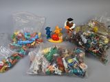 a lot of small plastic toys in bags on the table