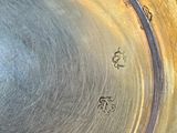 a close up of a metal bowl with writing on it