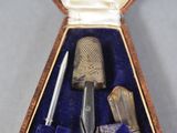a box with a pair of scissors and a thimble in it