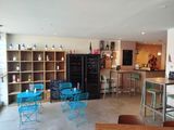 tables and chairs in a room with a chalk board on the wall