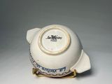 a small white bowl with a blue and white design on it