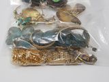 a bag of assorted jewelry sitting on a table