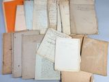 several old papers are stacked on top of each other on a table
