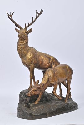 statue of a stag and a baby stag on a rock