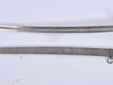 two old swords are laying next to each other on a white surface